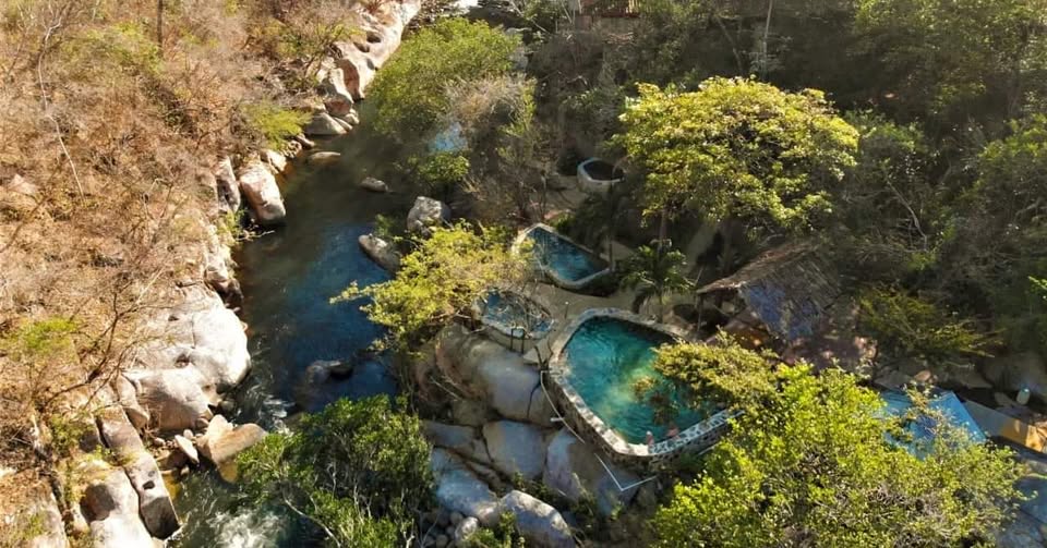 Aerial view of natural hot spring pools on the Adrenaline Mega Combo tour